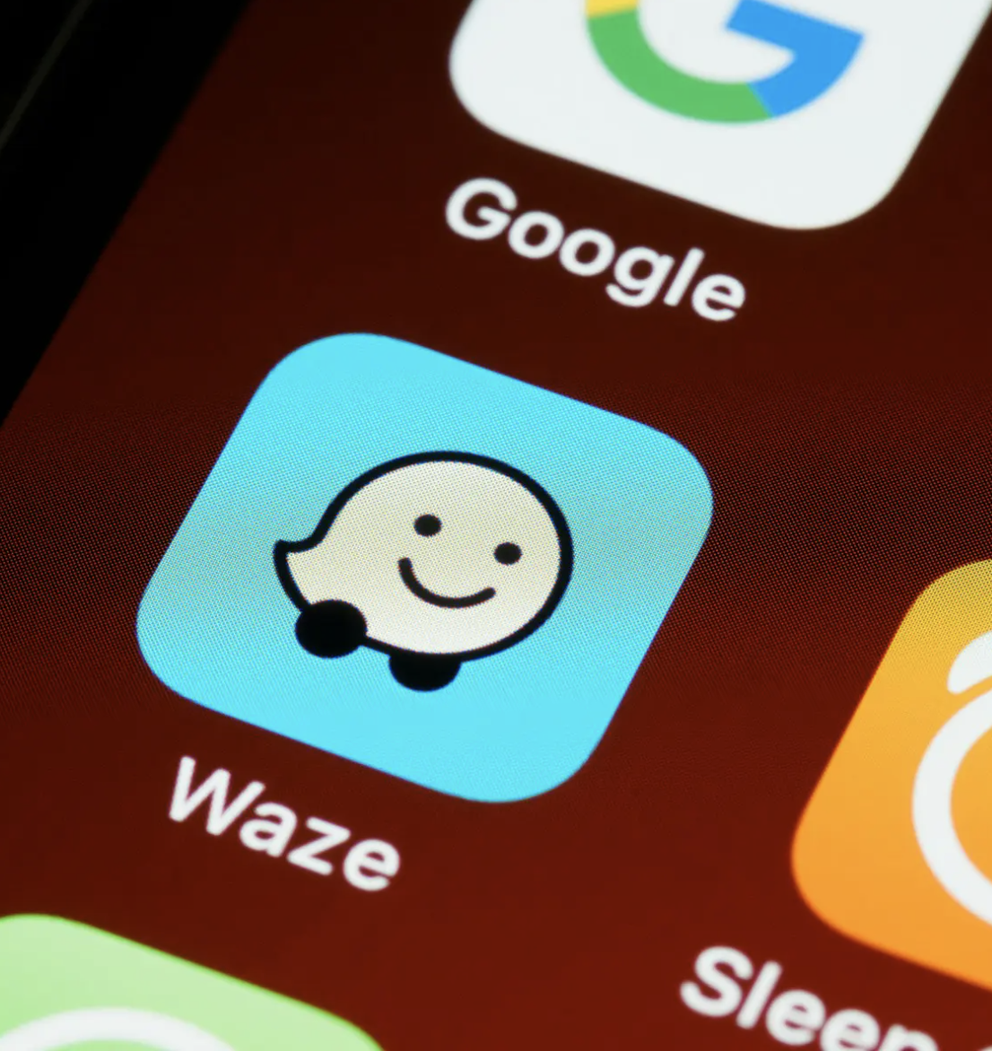 Waze app icon on smartphone screen with Google app above it